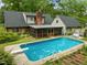 Large in-ground pool with a screened in porch area attached to the house at 3516 Swift Dr, Raleigh, NC 27606