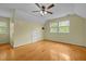 Spacious bedroom with hardwood floors, neutral walls, ceiling fan, and ample natural light at 3516 Swift Dr, Raleigh, NC 27606