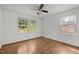 Bright, airy bedroom with hardwood floors and ample natural light from two windows overlooking the yard at 3516 Swift Dr, Raleigh, NC 27606