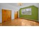 Cozy bedroom featuring hardwood floors, neutral walls, and built-in closet space at 3516 Swift Dr, Raleigh, NC 27606