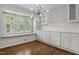 Bright dining area featuring a window seat, custom cabinetry, and modern light fixtures at 3516 Swift Dr, Raleigh, NC 27606