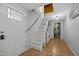 Inviting entryway featuring hardwood floors, stairs to upper level, and laundry room access at 3516 Swift Dr, Raleigh, NC 27606