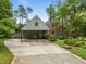 Charming home exterior featuring a carport, brick accents, and mature landscaping at 3516 Swift Dr, Raleigh, NC 27606