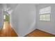 Hallway with hardwood floors and natural light from a window on one end at 3516 Swift Dr, Raleigh, NC 27606