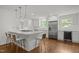 Modern kitchen featuring a large island, stainless steel appliances, and sleek white cabinetry at 3516 Swift Dr, Raleigh, NC 27606