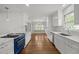 Spacious, updated kitchen with white cabinets, marble countertops, and modern appliances for cooking at 3516 Swift Dr, Raleigh, NC 27606