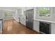 Stylish kitchen with stainless steel appliances, white cabinetry, wine cooler, and ample natural light at 3516 Swift Dr, Raleigh, NC 27606