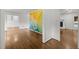 Spacious living room with hardwood floors, a decorative wall mural, and a fireplace at 3516 Swift Dr, Raleigh, NC 27606