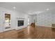Bright living area with hardwood floors, a fireplace, a staircase, and access to an outdoor area at 3516 Swift Dr, Raleigh, NC 27606