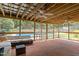 Screened-in patio with ceiling fans, outdoor furniture, and views of the backyard pool at 3516 Swift Dr, Raleigh, NC 27606