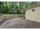 A backyard patio with brick pavers, trees, and landscaping elements at 3517 Eden Croft Dr, Raleigh, NC 27612