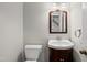 Bathroom featuring a single sink vanity, decorative mirror, and convenient toilet at 3517 Eden Croft Dr, Raleigh, NC 27612