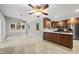 Bright kitchen with stainless appliances, custom cabinets, and adjacent breakfast nook featuring a ceiling fan at 3517 Eden Croft Dr, Raleigh, NC 27612
