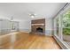 Spacious living room featuring a cozy brick fireplace, large windows offering lots of natural light at 3517 Eden Croft Dr, Raleigh, NC 27612