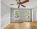 Spacious living room with hardwood floors, neutral paint, and an elegant ceiling fan at 3517 Eden Croft Dr, Raleigh, NC 27612