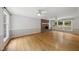 Bright living room featuring a brick fireplace, large windows and gleaming hardwood floors at 3517 Eden Croft Dr, Raleigh, NC 27612