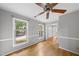 Living room with hardwood floors and ample natural light streaming through large windows at 3517 Eden Croft Dr, Raleigh, NC 27612