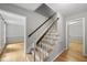 Inviting staircase with wooden banister and treads, leading to the upper level of this beautifully designed home at 3517 Eden Croft Dr, Raleigh, NC 27612