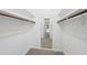 A spacious walk-in closet with ample storage featuring wooden rods and carpeted floors at 3517 Eden Croft Dr, Raleigh, NC 27612