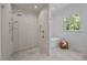 Modern bathroom with an open walk-in shower and soaking tub next to a large window at 387 Riverstone Dr, Pittsboro, NC 27312