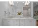 Elegant bathroom featuring double sinks with marble countertops and decorative fixtures at 387 Riverstone Dr, Pittsboro, NC 27312