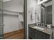 Bathroom featuring a dark green vanity, decorative mirror and a walk-in closet at 387 Riverstone Dr, Pittsboro, NC 27312