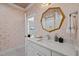 Elegant bathroom with patterned wallpaper, gold mirror, and granite countertop at 387 Riverstone Dr, Pittsboro, NC 27312