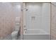 Bright bathroom featuring a shower-tub, patterned wallpaper, and white tiles at 387 Riverstone Dr, Pittsboro, NC 27312