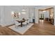 Elegant dining room with chandelier, hardwood floors, adjacent wine bar, and view to front entry at 387 Riverstone Dr, Pittsboro, NC 27312