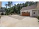 Spacious driveway with brick detailing leading to a well-maintained garage, enhancing the home's exterior appeal at 387 Riverstone Dr, Pittsboro, NC 27312