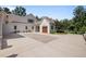 Expansive driveway featuring brick accents leading to a charming home with a well-manicured lawn at 387 Riverstone Dr, Pittsboro, NC 27312