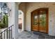 Close up of a home's entryway showcasing the stone porch, double doors, and brick facade at 387 Riverstone Dr, Pittsboro, NC 27312