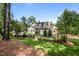 Beautiful two-story home with lush landscaping and mature trees, set back on a spacious lot at 387 Riverstone Dr, Pittsboro, NC 27312