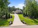 Beautiful home featuring a long driveway, well-manicured lawn and mature landscaping at 387 Riverstone Dr, Pittsboro, NC 27312