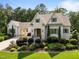 Charming two-story home with manicured landscaping, a light brick facade, and an attached carport at 387 Riverstone Dr, Pittsboro, NC 27312