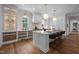 Spacious kitchen with a large island, pendant lighting, updated cabinets, and stainless steel appliances at 387 Riverstone Dr, Pittsboro, NC 27312