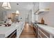 Well-appointed kitchen with a large island, white countertops, custom cabinetry, and open layout at 387 Riverstone Dr, Pittsboro, NC 27312