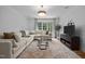 Bright and spacious living room with comfortable sectional sofa and modern décor, great for entertaining at 387 Riverstone Dr, Pittsboro, NC 27312