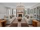 Spacious living room with fireplace, hardwood floors, recessed lights, and elegant furnishings at 387 Riverstone Dr, Pittsboro, NC 27312