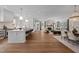 Open-concept living space showcasing the hardwood floors, spacious seating, and connected kitchen at 387 Riverstone Dr, Pittsboro, NC 27312