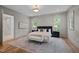 Large primary bedroom featuring hardwood floors, panel molding, recessed lighting, and ensuite bathroom at 387 Riverstone Dr, Pittsboro, NC 27312