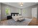 Beautiful main bedroom featuring paneled walls, hardwood floors, and a large decorative rug at 387 Riverstone Dr, Pittsboro, NC 27312