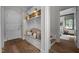 Mudroom with built-in storage bench and view of stairs and bedroom at 387 Riverstone Dr, Pittsboro, NC 27312