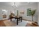 Well-lit home office with hardwood floors, modern chandelier, and beautiful natural light at 387 Riverstone Dr, Pittsboro, NC 27312