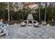 Inviting outdoor stone fireplace with comfortable seating creates a cozy ambiance for evening gatherings at 387 Riverstone Dr, Pittsboro, NC 27312
