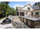 Outdoor kitchen with built-in grill, counter space, and stainless steel appliances for the ultimate grilling experience at 387 Riverstone Dr, Pittsboro, NC 27312
