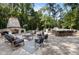Expansive stone patio with outdoor fireplace, kitchen, and bar offers a perfect space for relaxation and entertainment at 387 Riverstone Dr, Pittsboro, NC 27312