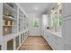 Spacious pantry featuring white cabinetry, quartz countertops, hardwood floors and built in shelving at 387 Riverstone Dr, Pittsboro, NC 27312
