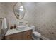 Stylish powder room featuring a unique geometric wallpaper and gold accents at 387 Riverstone Dr, Pittsboro, NC 27312