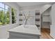 Spacious walk-in closet with custom shelving, a large island, and a window at 387 Riverstone Dr, Pittsboro, NC 27312